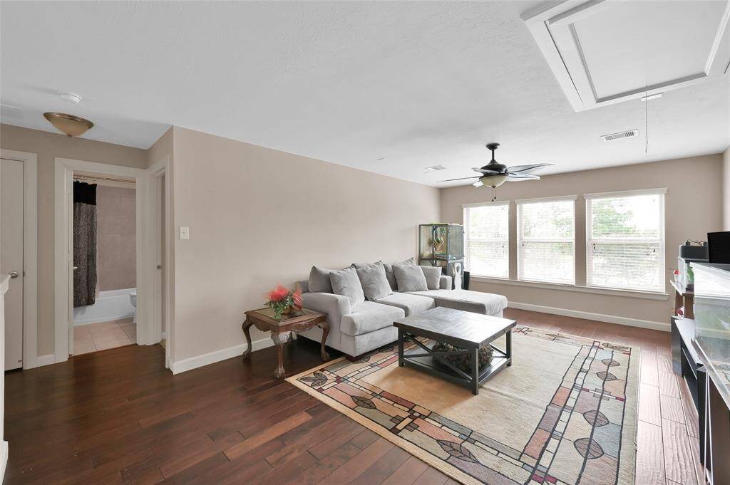 Upstairs is a large game room with hand scraped wood floors. Plenty of light in this space and the perfect spot for the kids to hangout with friends.