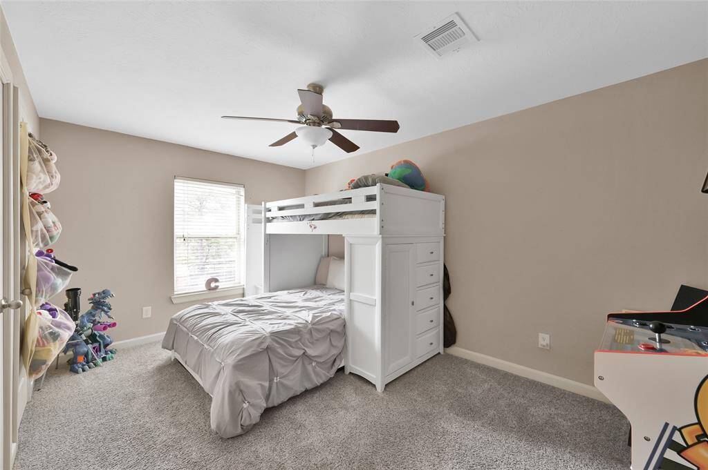 There are four bedrooms and two full baths upstairs!  The bedrooms are carpeted and this bedroom has a ceiling fan.