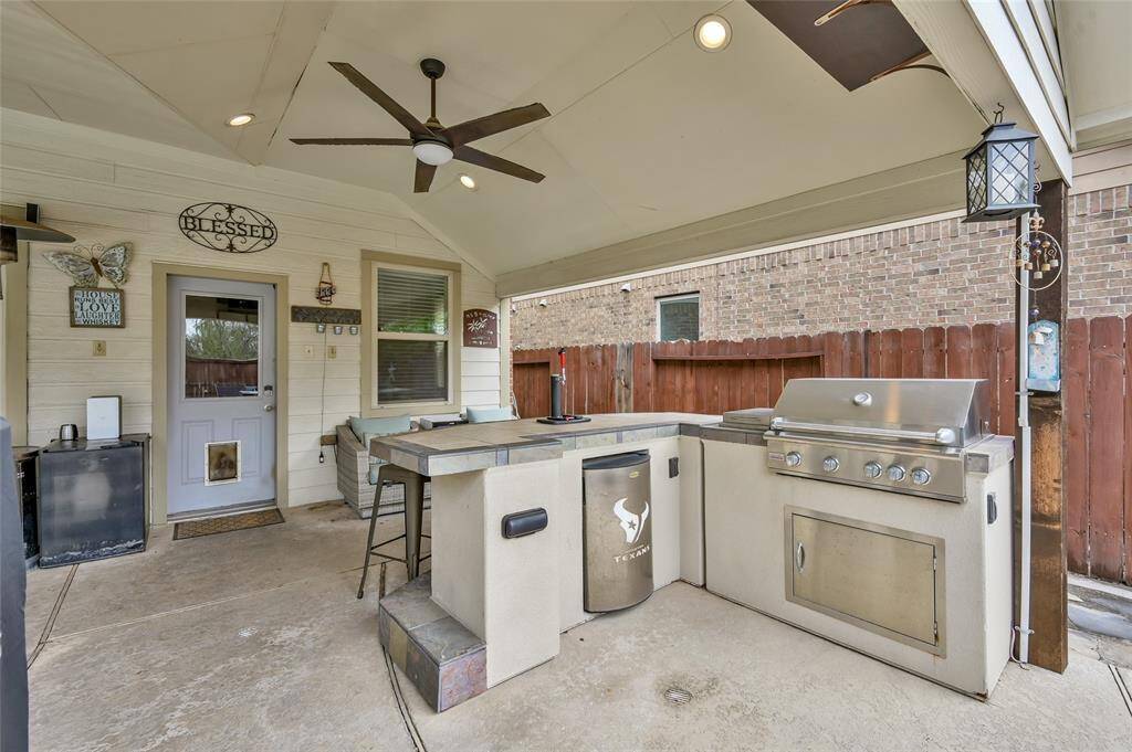 Outside is this summer kitchen complete with a built-in grill and a kegerator!
