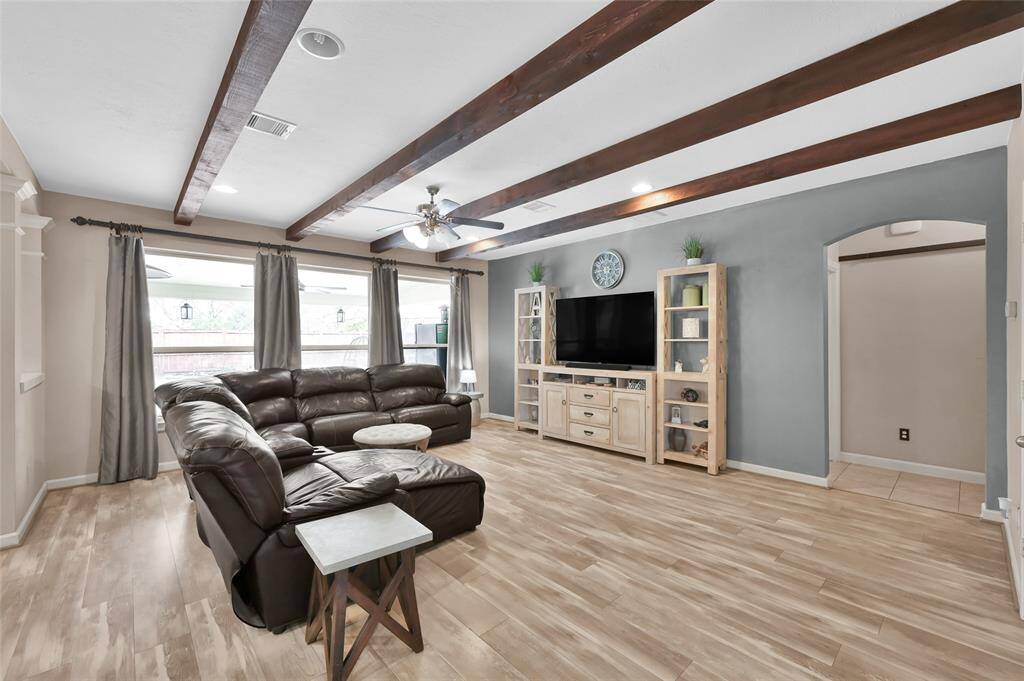 The large windows in the family room gives a great view of the backyard oasis. The room has recessed lights and a ceiling fan.