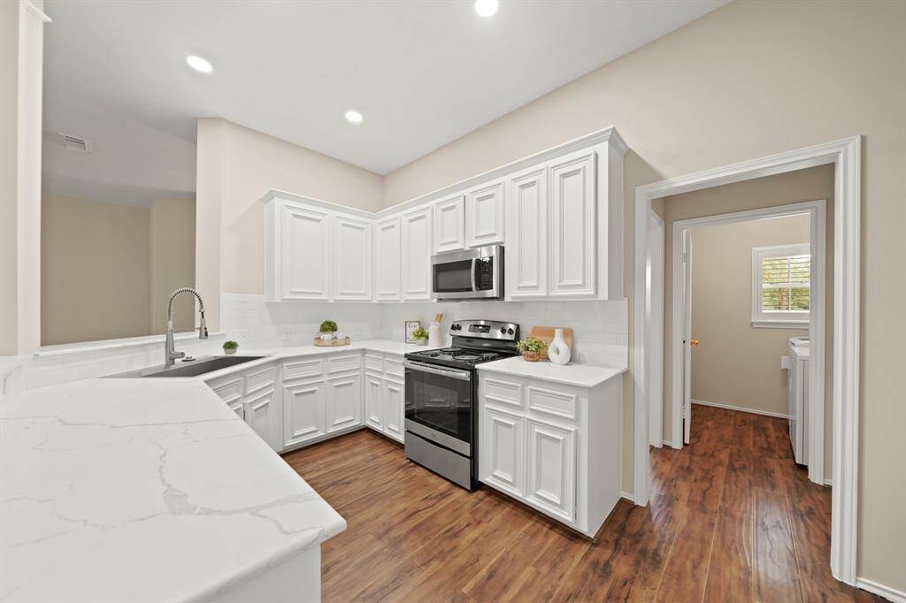 Freshly renovated kitchen with gleaming new counters and updated finishes.
