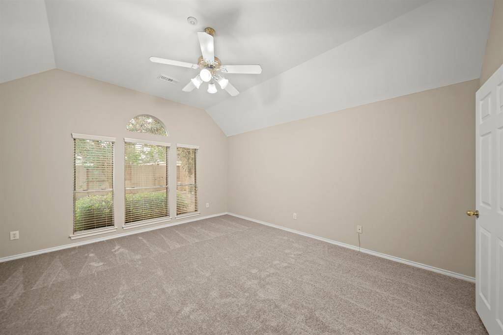 Retreat to a serene primary suite with ample space and natural light
