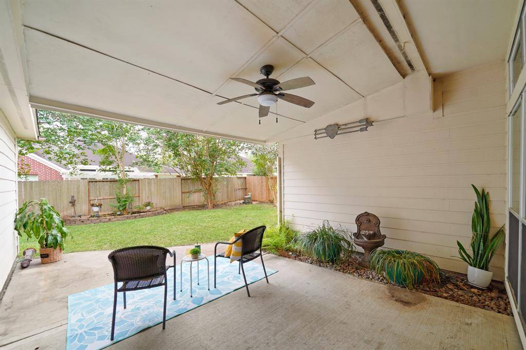 Enjoy year-round relaxation under the covered patio overlooking the backyard.