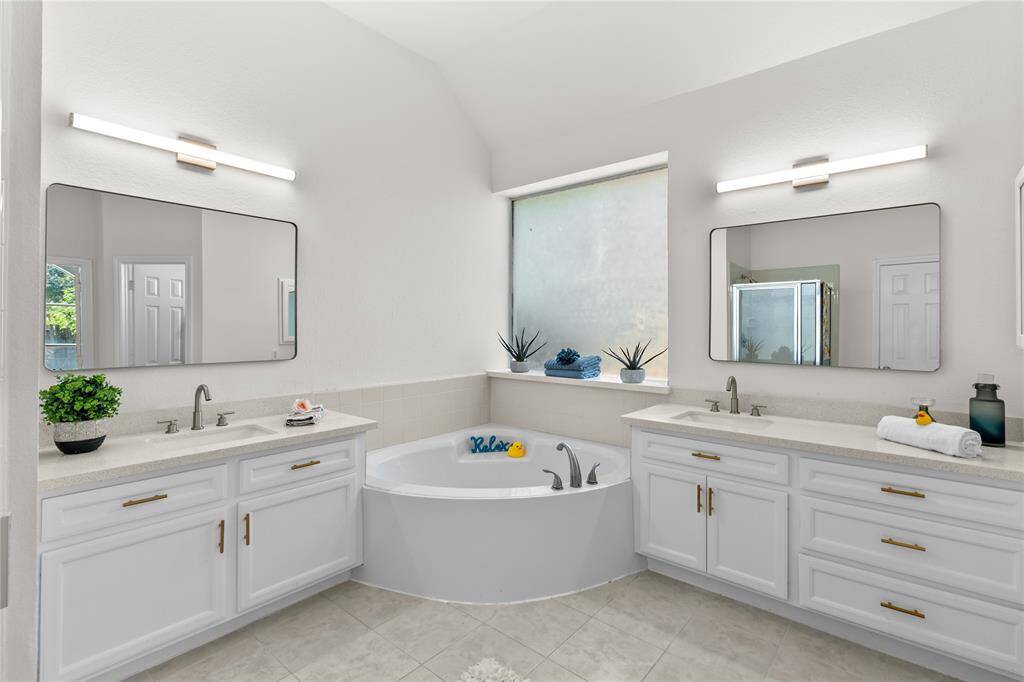 Primary bath with soaking tub and separate shower.