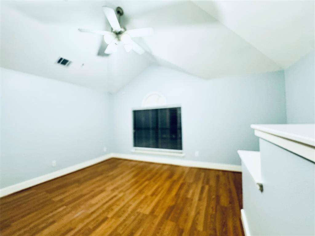 Spacious primary bedroom with built in entertainment counters.