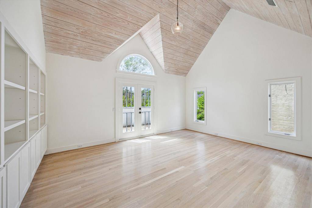 Primary bedroom with vaulted ceiling