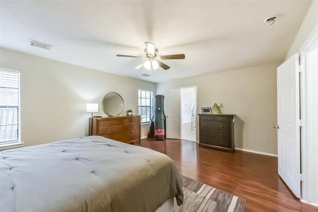 Two large windows fill the room with morning light while the neutral tones and sleek ceiling fan add to the calming vibe. You may never want to leave!