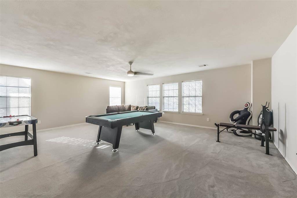 Welcome upstairs! Room to Play! This expansive upstairs game room offers the perfect space for movie nights, game tournaments, and hanging out with family and friends.