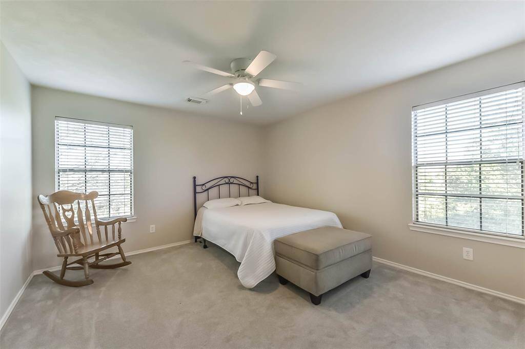 A peaceful retreat upstairs—this secondary bedroom offers soft natural light, neutral tones, and space to truly unwind.