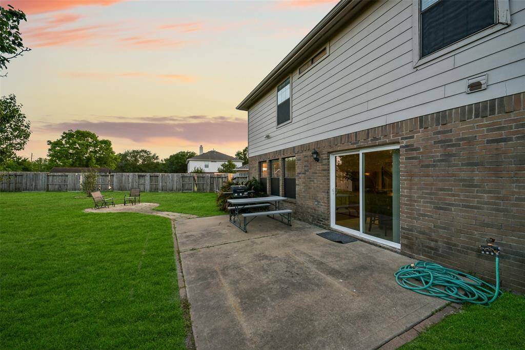 Slide open the patio door and step onto your spacious concrete patio—perfect for backyard BBQs, outdoor dining, and soaking up those golden hour vibes.