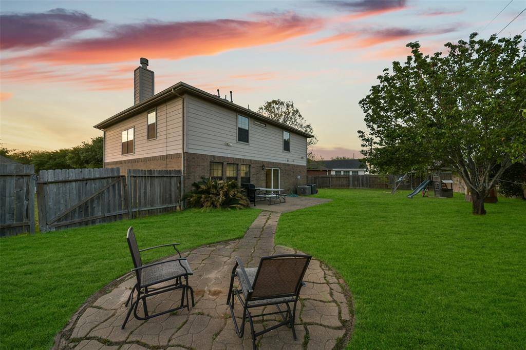A charming stone path leads to a cozy firepit-style seating area—ideal for stargazing, s’mores, or a quiet evening glass of wine.