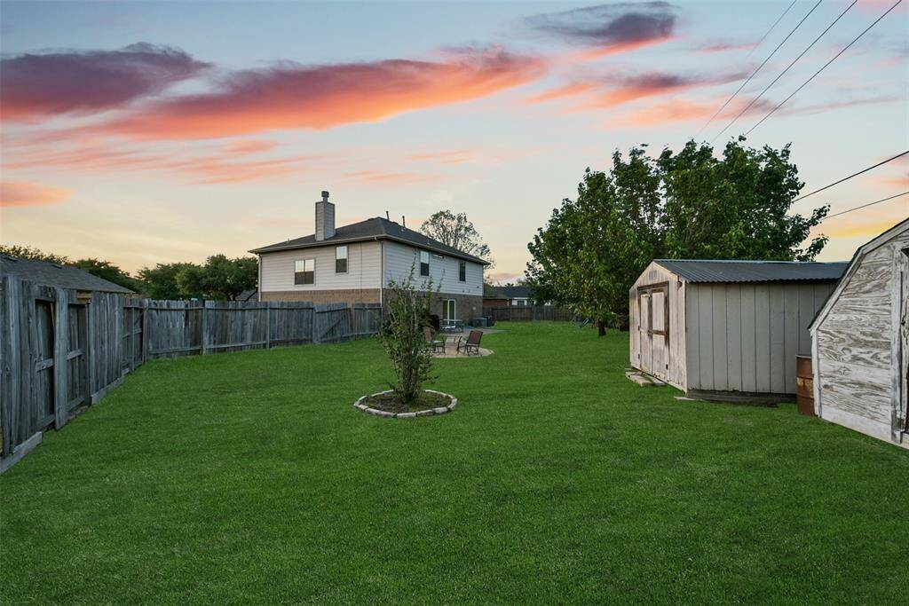 A fully fenced yard with plenty of grassy space for pets, playtime, or maybe even your future pool dreams.