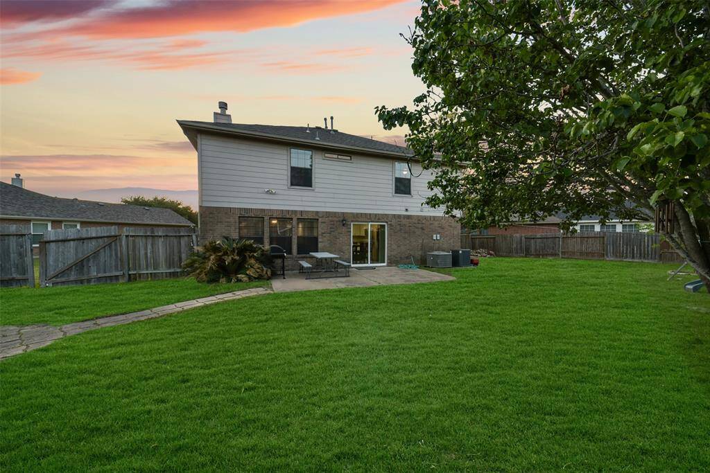 Let the kids play freely with a swing set and shaded yard, while the grown-ups relax nearby. This backyard is ready for memories in the making.