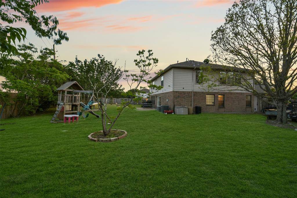 Let the kids play freely with a swing set and shaded yard, while the grown-ups relax nearby. This backyard is ready for memories in the making.