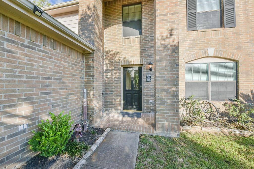 A stylish black front door sets the tone for the warm and inviting interior just beyond. Whether it’s game night or a quiet evening in, this entrance is ready to welcome you home.