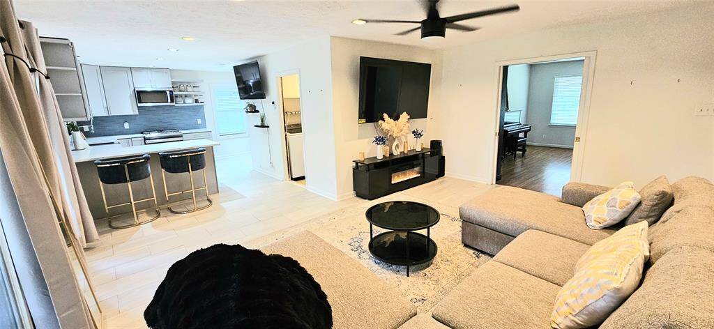 The kitchen flows effortlessly into the living area, creating an open-concept layout that’s perfect for easy family gatherings and seamless entertaining.