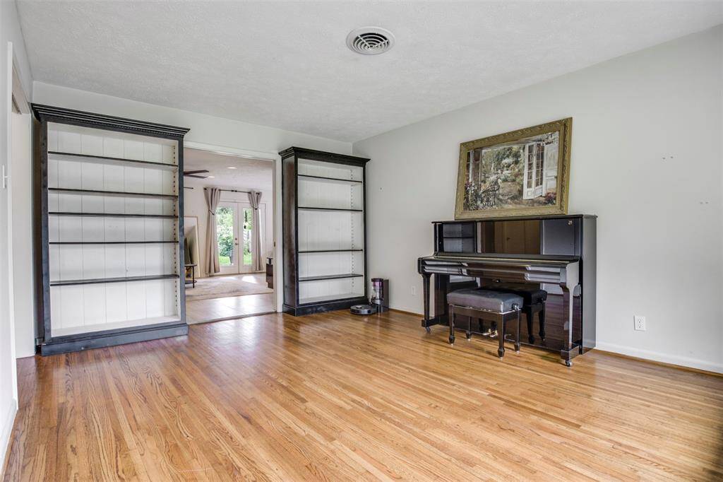 The Spacious dining room is designed for quality family time, featuring beautiful wood flooring and a large window that fills the space with warm natural light.