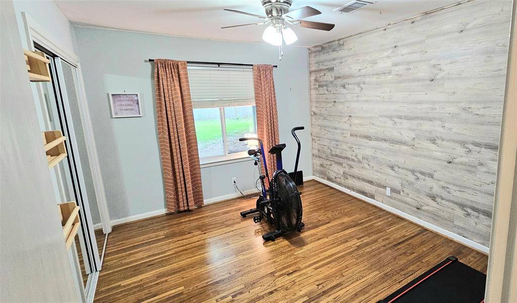 Whether you envision a workout room, nursery, or home office, this versatile first bedroom adapts to your lifestyle. Featuring a stylish accent wall, this space is sure to stand out no matter how you choose to make it your own.