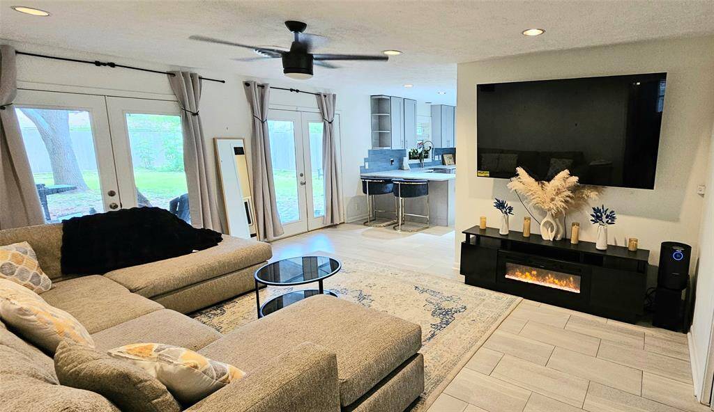 A spacious family room flows seamlessly into the elegant double-door dining area—an ideal open-concept space for effortless entertaining and memorable gatherings.