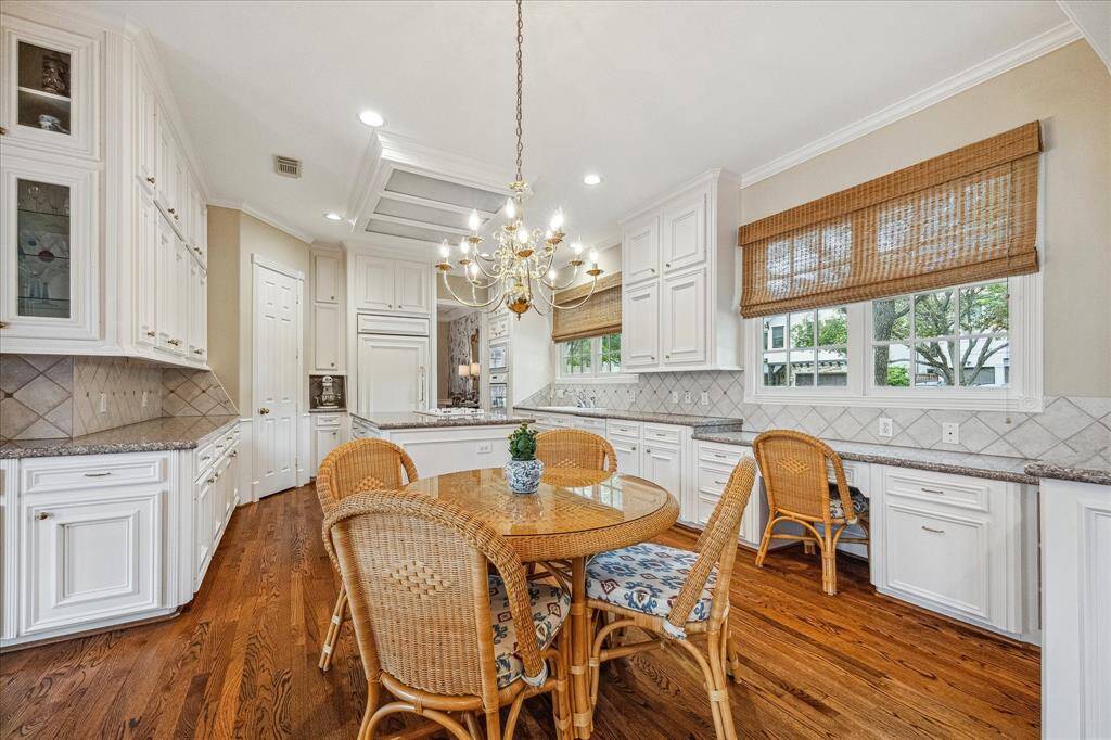 The chef's kitchen is great for multiple cooks with its significant amount of counter space, fabulous storage and lovely windows viewing the lovely side yard on the corner.