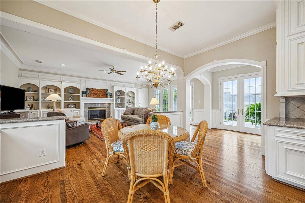 The kitchen and breakfast room are quite open to the family room allowing everyone to enjoy time together. Note the double French doors leading to the large backyard.