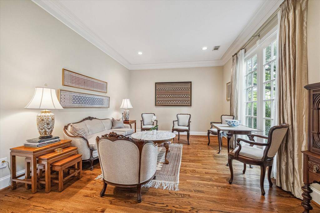 The gracious living room also overlooks the lovely front yard with mature landscaping and majestic trees.
