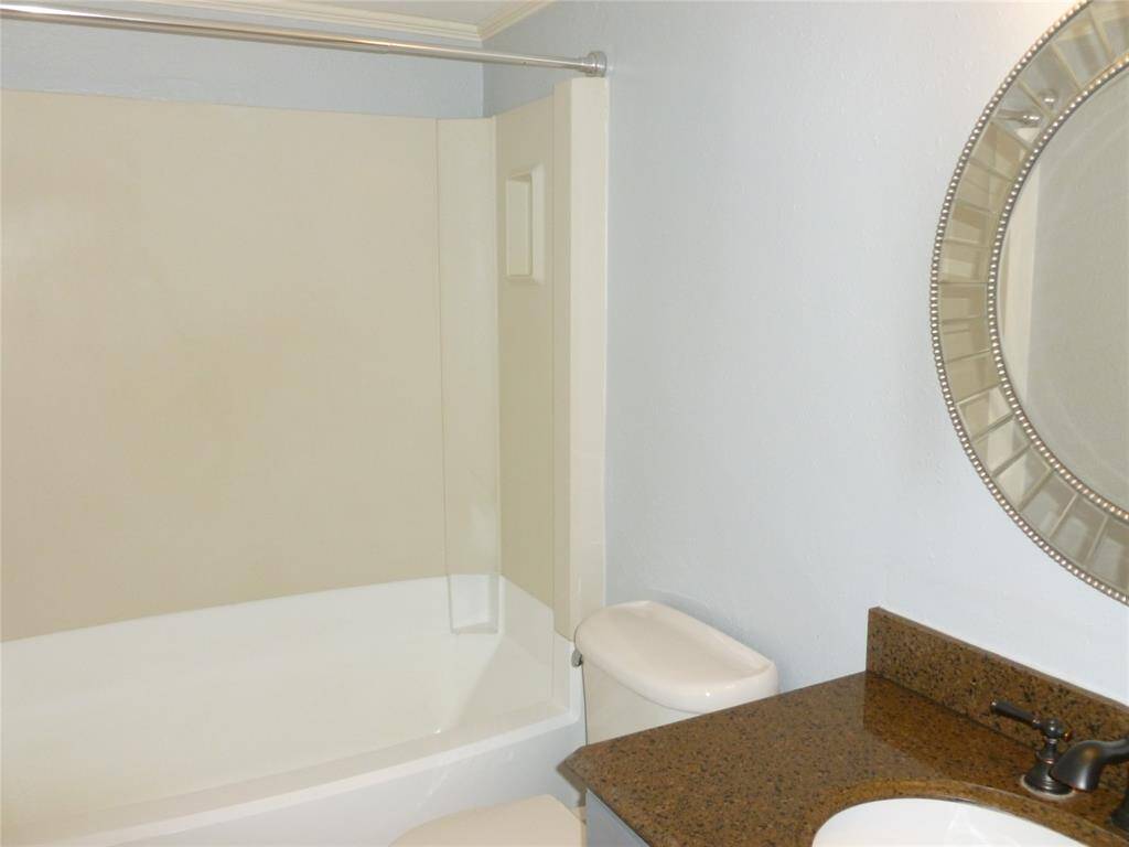 Secondary hall bathroom has a soaker tub with shower
