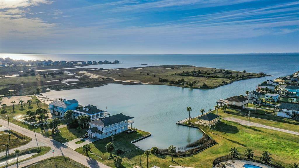This photo showcases a serene coastal neighborhood with waterfront homes, offering stunning views of the ocean and nearby bay. Ideal for those seeking a peaceful, picturesque setting with direct water access.
