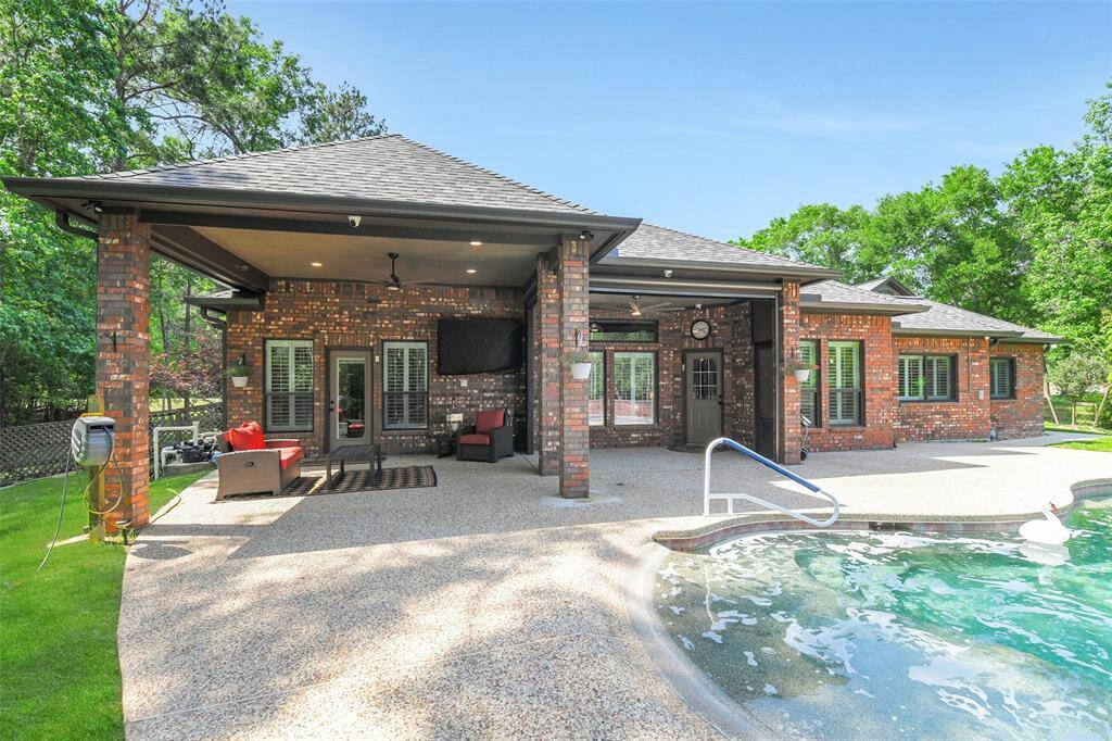 Back Covered patio area has plenty of space for outdoor dining, sitting and watching your favorite game with friends.