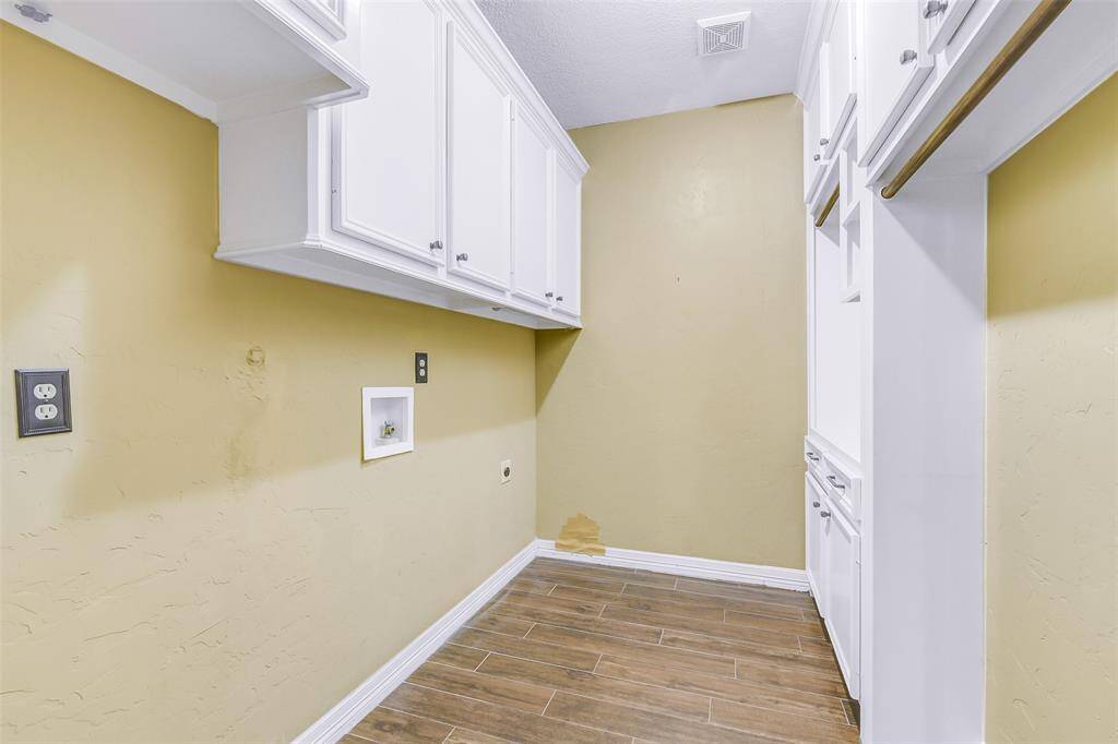 Laundry room has tons of storage space, room for a freezer or fridge.