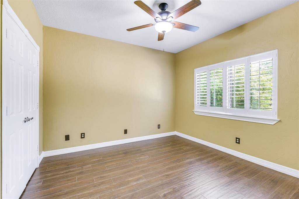 Secondary Bedroom with tile floors, updated ceiling fan, Plantation shutters.