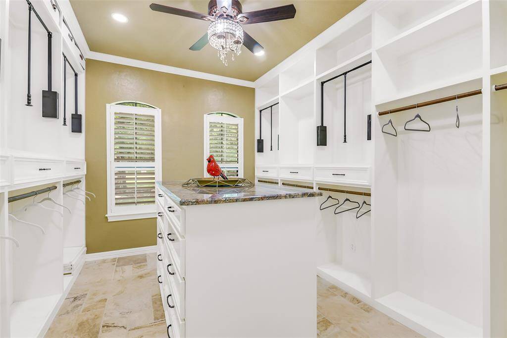 Custom built closet with extensive built-ins. Not shown in this photo are the two floor to ceiling cabinets in this space.