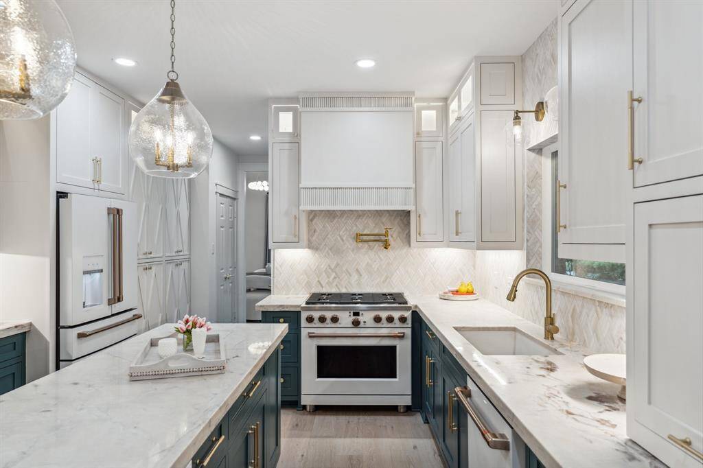 Featuring under cabinet lighting, ceiling-high cabinets with top lights, pot filler, and newly added storage in addition to a large pantry.