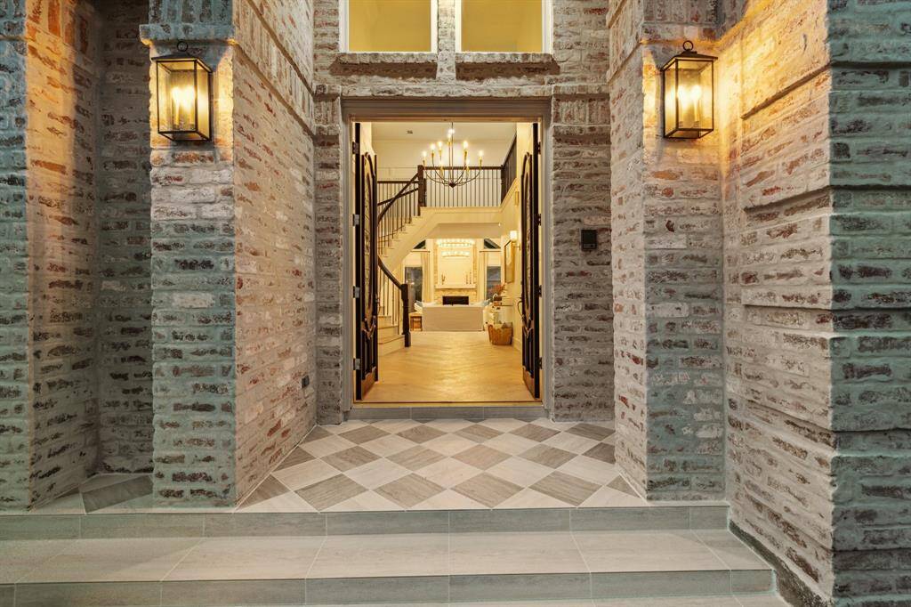 Newly tiled front and back porches add to the charm and attractive facade of this incredible Houston home.