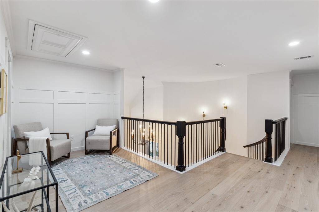 This great landing space can be used in a variety of ways - a play area, homework area, second office area, or just a sitting area - whatever you choose! Also notice the custom wood detail on the wall.
