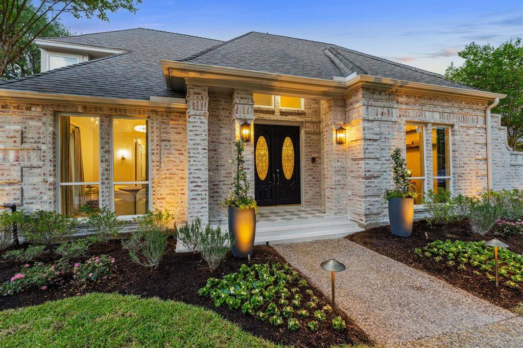 New landscaping, lighting, and pots have been added to this stunning home.