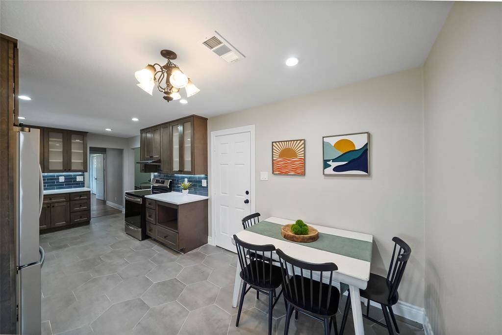 This space at the end of the kitchen could be used as a breakfast nook or office space. The door shown in the picture is access to your 2 car garage with convenient carport.