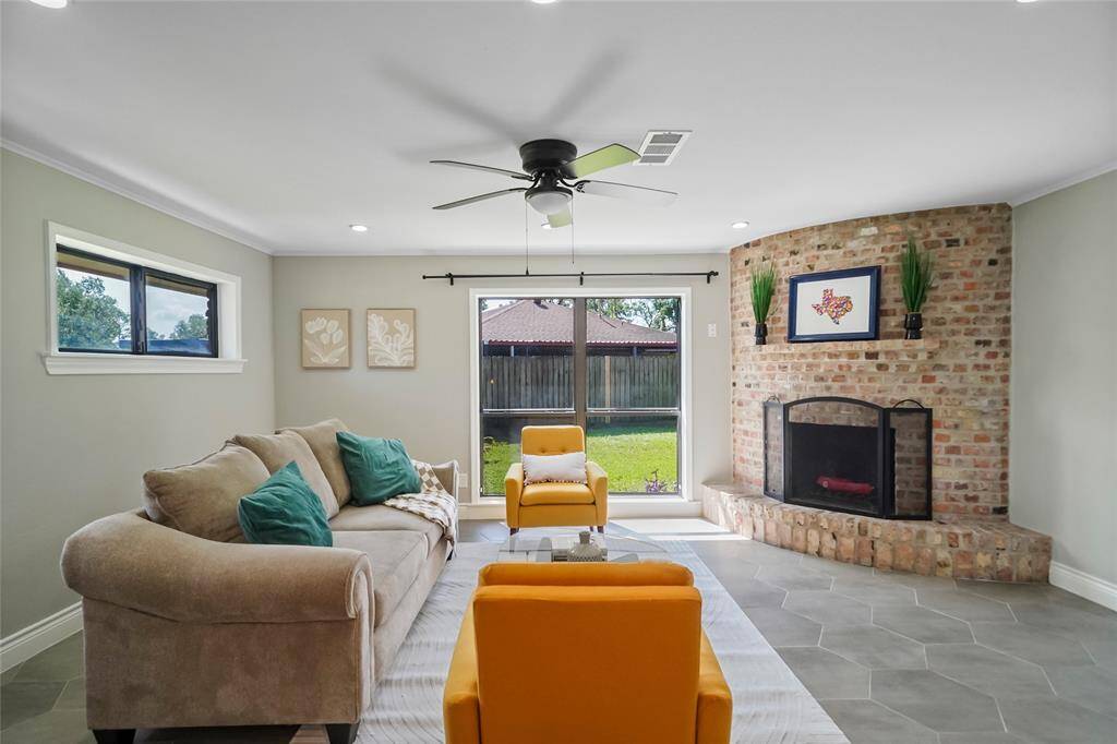 Off of the kitchen at the rear of the house is your large den area with wood burning fireplace.