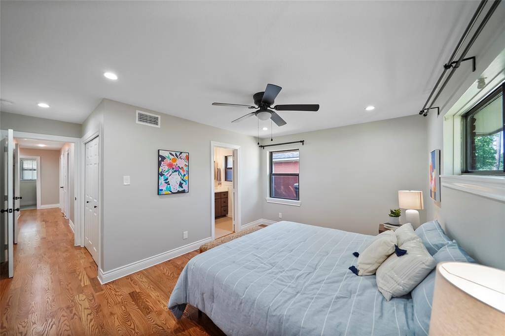 Large windows fill the room with natural light, complemented by a spacious closet and an ensuite primary bathroom for added convenience.