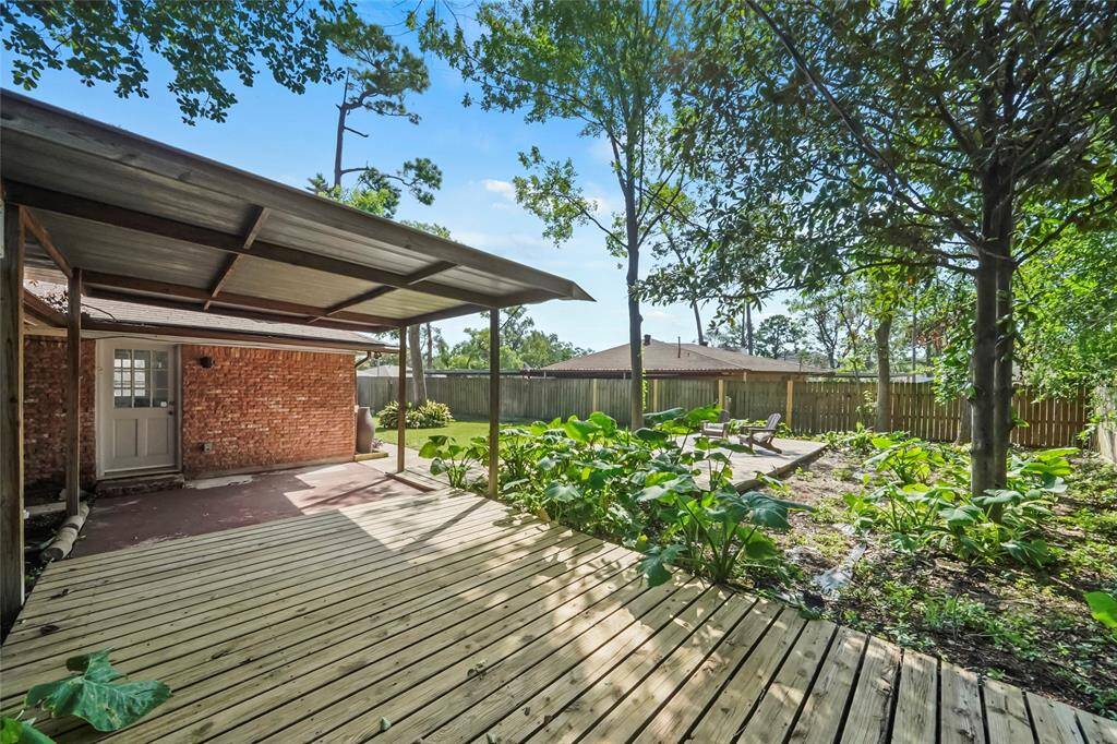 Step out from the den onto this covered patio, the perfect spot to enjoy a cup of coffee before starting a busy morning.