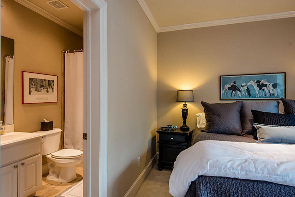 First level features two car garage, bedroom, and bathroom.