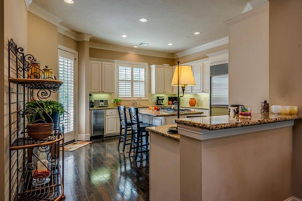 An oversized gourmet island kitchen is a chef s delight! It offers luxurious granite counters, plenty of cabinet space, stainless steel appliances, island seating, and a breakfast bar!