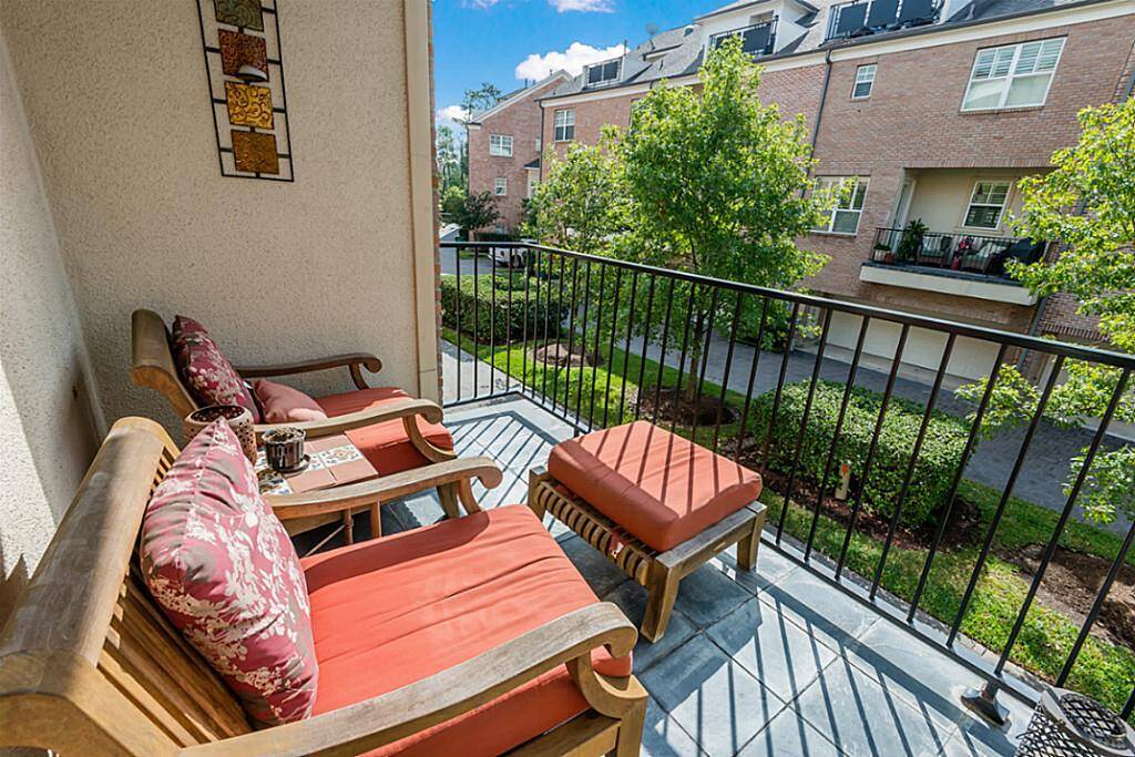 From the kitchen, you have access to this charming balcony! It is equipped with scenic views, & plenty of space to relax & unwind! Plus, with the living room, dining room, kitchen & balcony together on one floor, entertainment options are limitless!