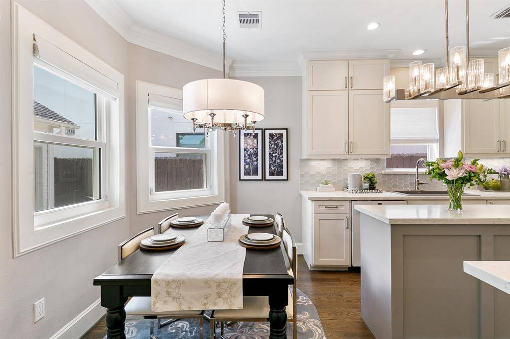 The charm continues into the breakfast room with the craftsman style windows and elegant light fixture.