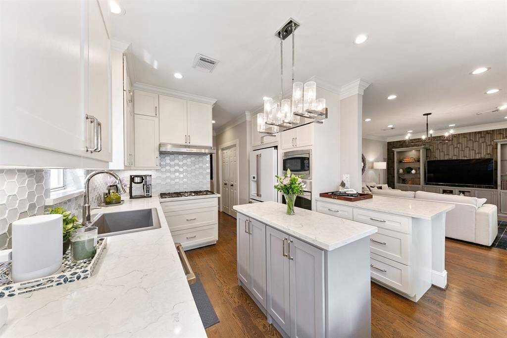 The kitchen offers ample storage space with the cabinets that reach to the ceiling and beautifully positioned center island.