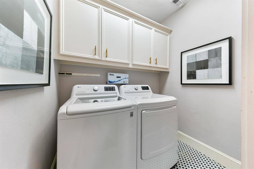 Utility room is located on the first floor of the home and features an O3 Waterworks built-in laundry system.