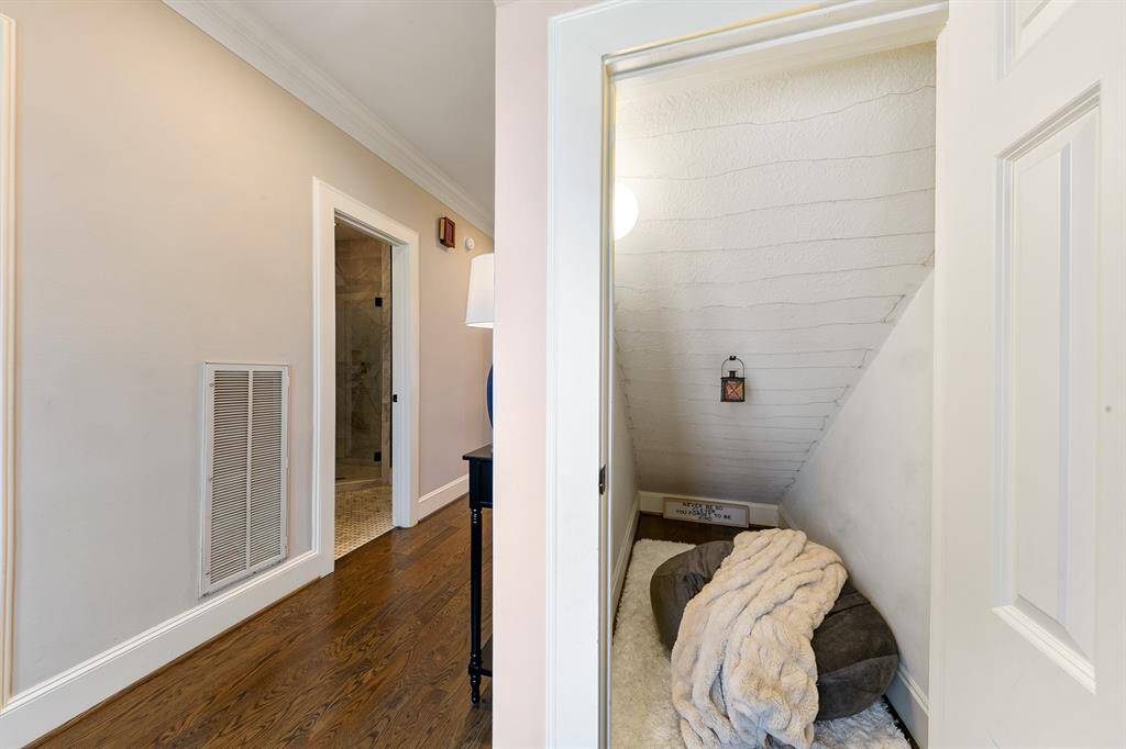 Charming closet under the staircase is currently set up for a cozy reading room.