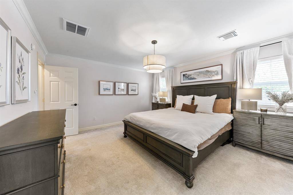 Upstairs primary bedroom is spacious.  It provides ample room for a king size bed, large nightstands and a dresser.