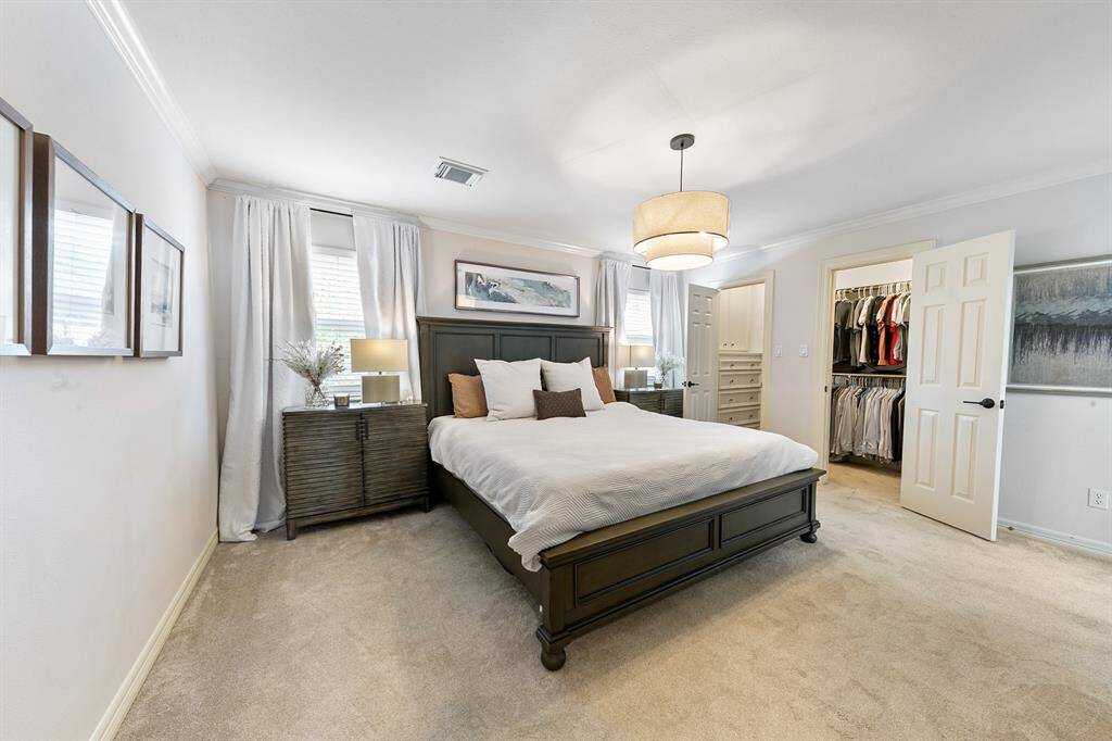 The primary bedroom is a retreat with an updated light fixture and ensuite primary bathroom.