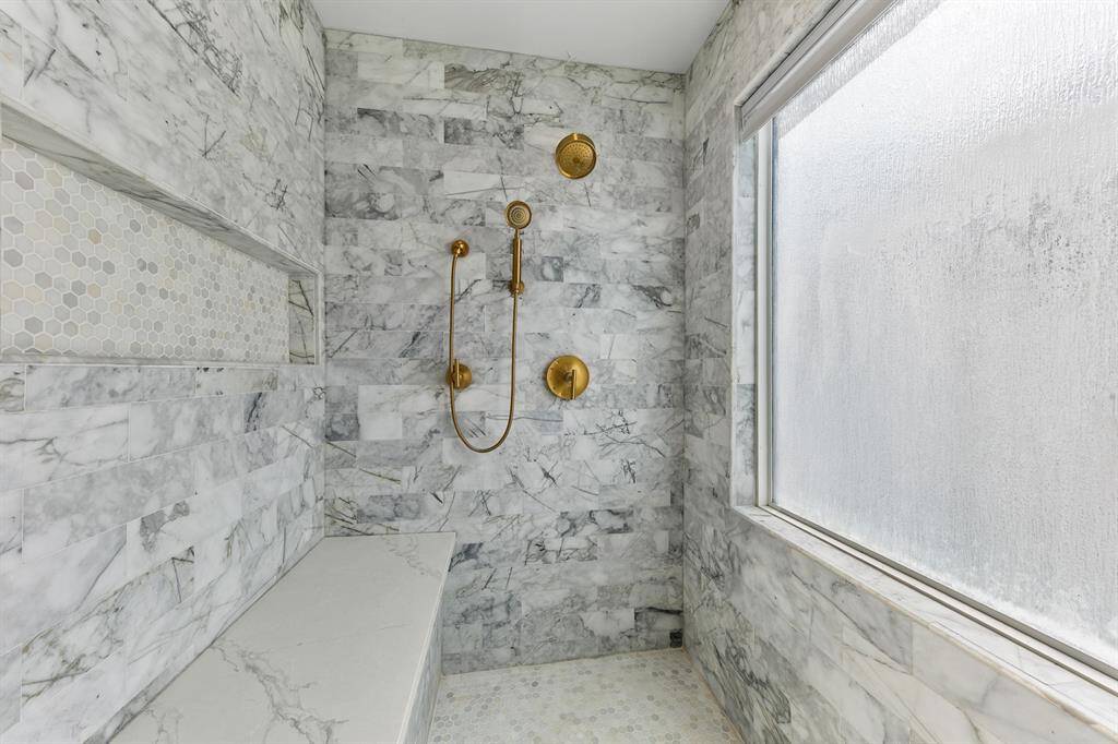This oversized walk-in shower is breathtaking.  The tile work and fixtures are stunning.